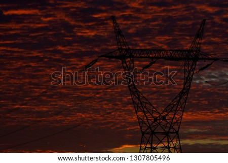 masts high voltage against the background of the setting sun