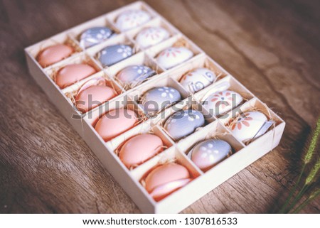 Easter eggs hand painted inside a gift box, photo for advertising use.