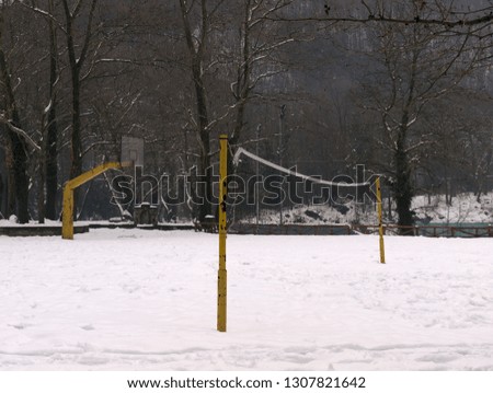 Basketball and volleyball fields coverd with snow, in Agios Nikolaos (Saint Nicholas) park in Naousa Greece.