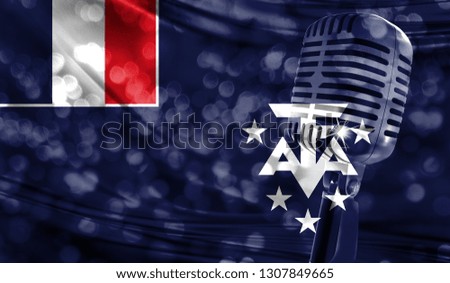 Microphone on a background of a blurry French Southern and Antarctic Lands flag close-up