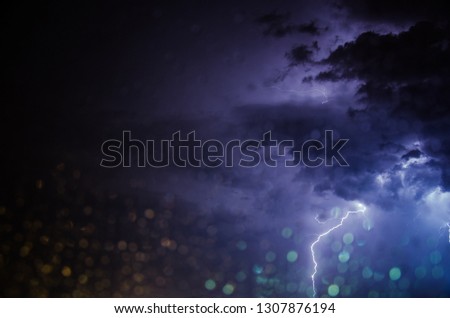 Lightning storm through a window on a rainy night