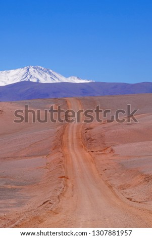 Beautiful Andes landscape and the road leading to Paso Pircas Negras mountain pass, Argentina to Chile, snow covered high mountains in the background, La Rioja, South America