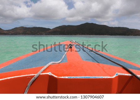 Red boat at Indian Ocean at sunset, Seychelles