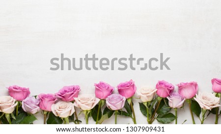 Floral pattern made of pink and beige roses on white background. Flat lay, top view. Valentine's background