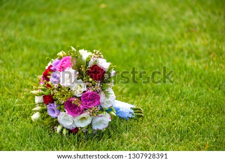 picture of a wedding bouquet , Wedding bouquet of pink and white roses lying on grass.