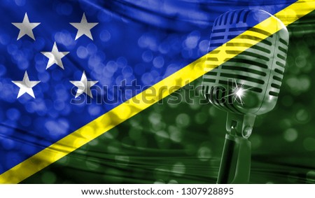 Microphone on a background of a blurry Solomon Islands flag close-up