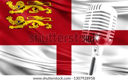 Microphone on fabric background of flag of Sark close-up