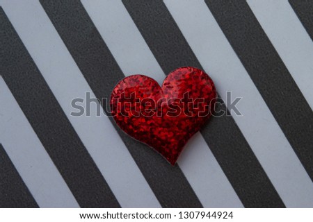 red heart on black and white striped background