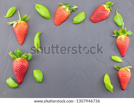Fresh strawberries on a rustic black tile