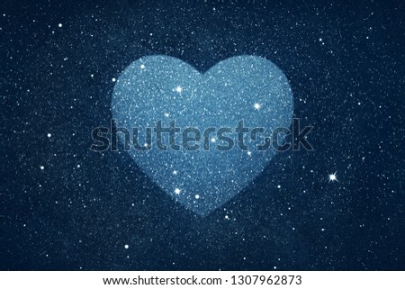 Stars in heart shape over blue night sky background
