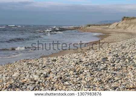 Pebbled beach with waves in background, Esposende, Portugal.