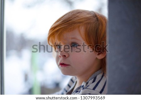 beautiful little girl with red hair by the window,redheaded little girl,pretty baby