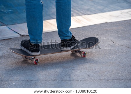  a Skater riding the skate  in a skate park only from the knee down