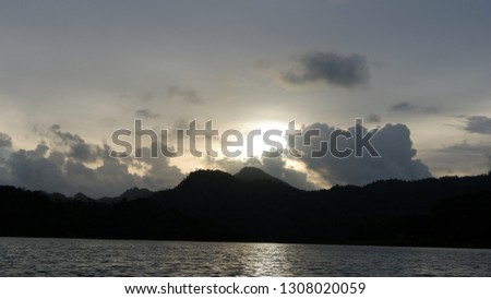 the view of the reddish blue sky at the lake at sunset