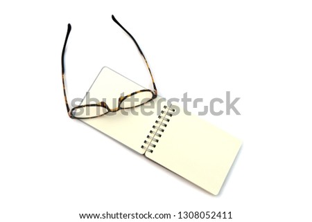 Blank Page of Short Notebook with eyeglass, concept and idea, isolated on white background 