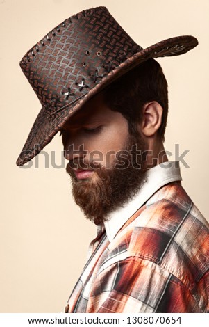 Young handsome man in a cowboy hat