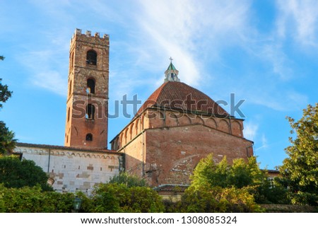 The church of SS.Giovanni e Reparata back view with bell tower made from red brick and baptistery large dome on the blue sky background, Tuscany, Italy