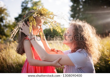 Mom hugs little daughter in nature in summer. Family, children and happy people concept