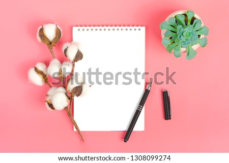 Notebook for records, pen and sprig of cotton, succulent, cactus on pink background Place for text Flat lay Top view Goals,Means, Resolution concept