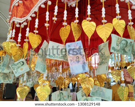 stripe of bank note garland in temple, people donate money, Thailand
