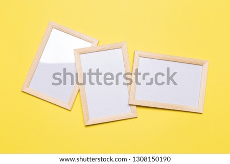 three blank frame on a yellow background. concept