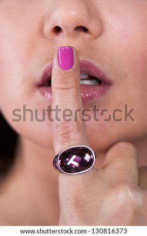 Close-up Of Woman With Finger On Her Lips