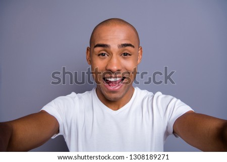 Close up photo funky dark skin he him his macho short hairdo make take selfies video call glad opened mouth cool see relatives friends wearing white t-shirt outfit clothes isolated grey background