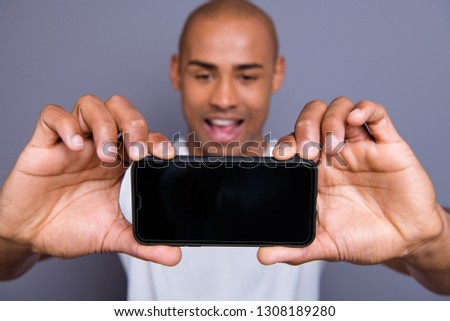 Close up photo attractive dark skin he him his macho short hairdo make take selfies on main telephone camera yeah yes facial expression wearing white t-shirt outfit clothes isolated grey background