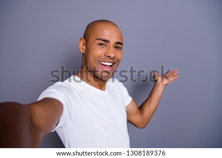 Close up photo healthy masculine dark skin he him his macho bald head make take selfies video translation blog show way for foreigners wearing white t-shirt outfit clothes isolated grey background