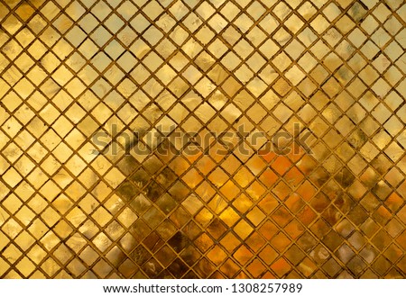 Golden mosaic wall with abstract reflection