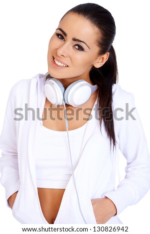 Full body of a female relaxing with music on her headphones and digital player