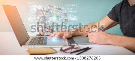 Graphic designer in ofice using wireframe holographic 3D digital projection of an engine