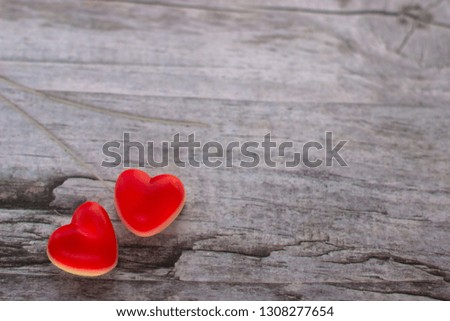 Red jelly hearts on the wooden background. Copy space area.  Valentine Day Concept.