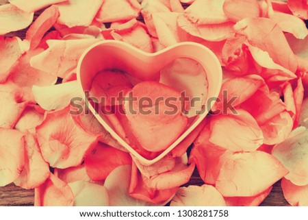 vintage Pink heart on Background the petals of roses.