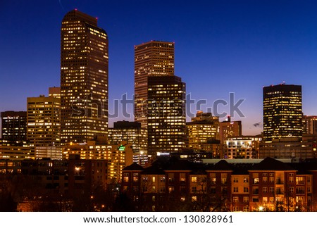 Close up of Denver Colorado skyline at dusk during the blue hour with lighted buildings