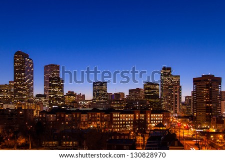 Denver Colorado skyline at dusk during the blue hour with lighted buildings and streets