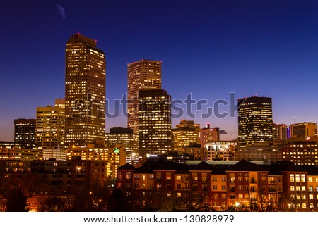 Close up of Denver Colorado skyline at dusk during the blue hour with lighted buildings and streets