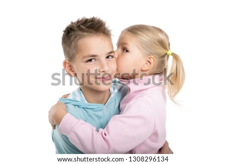 Little girl kissing beautiful boy isolated on white background