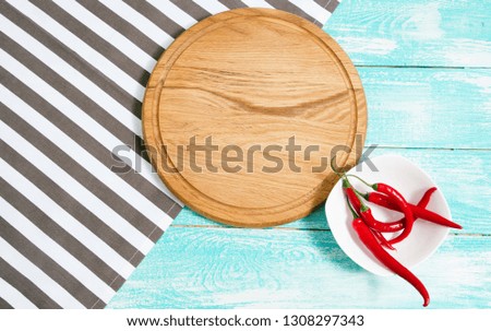 top view - Empty wooden platter with napkin on  table, copy space. Wooden cutting board over white concrete background