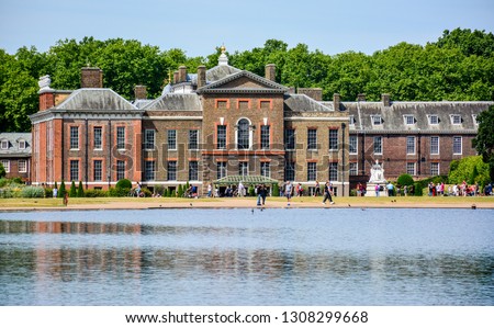 The facade of Kensington Palace, an official residence of the British Royal Family, with the Round Pond in Kensington Gardens, London, England