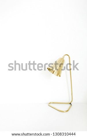 Golden lamp on white background. Minimal interior design concept.