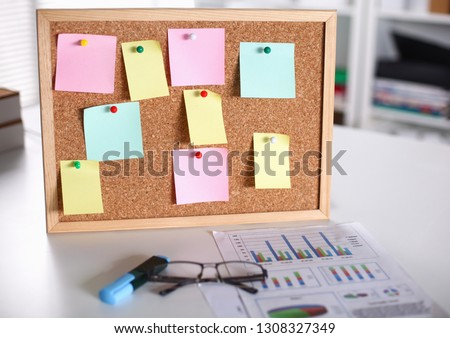 multicolored stickers on the board in the office