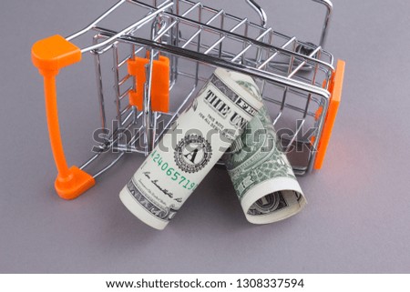 One Dollar paper currency and shopping cart