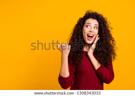 Close up photo beautiful cheerful amazing her she lady showing way one arm thumb other cheek wondered look empty space wearing red knitted sweater pullover clothes outfit isolated yellow background Royalty-Free Stock Photo #1308343033