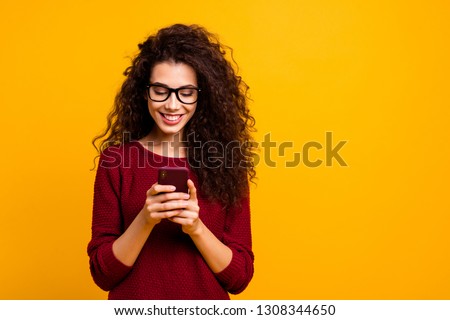 Portrait of her she nice lovely attractive pretty cheerful cheery wavy-haired lady holding in hands cell playing game free time isolated over bright vivid shine orange background Royalty-Free Stock Photo #1308344650