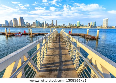 The view on San Diego Downtown skyline from the wooden pier with boardwalk on Coronado Island in San Diego Bay. Travel summer destination in California West Coast, United States.