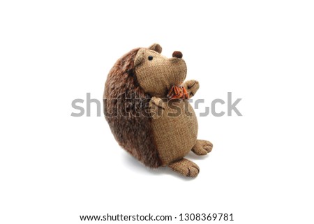 Children's doll small brown porcupine doll with bowtie isolated background 