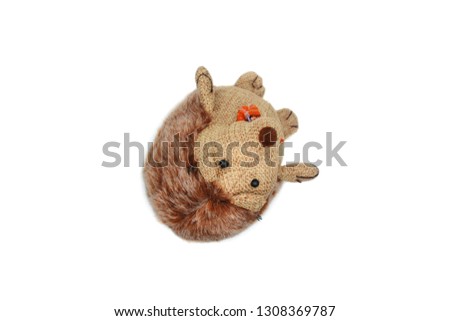 Children's doll small brown porcupine doll with bowtie isolated background 