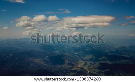 aerial photography clouds sky peaks of the Altai mountains, the sunlight shadows the winding road