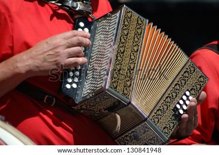 man playing accordian in a band at an open air concert, Greymouth, Westland, New Zealand